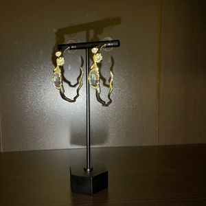 Gold Kendra Scott hoop earrings.